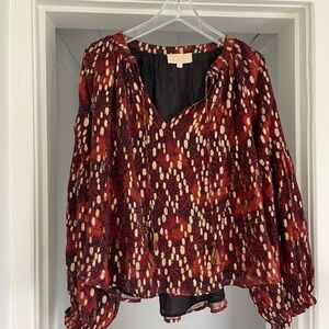 Anthropologie top size M has gold detail.